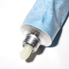 Pacifica compact tube next to passport, travel-ready and TSA-friendly