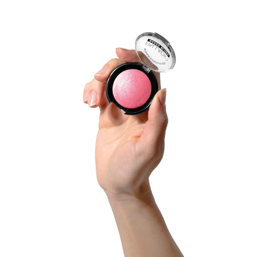 Palladio compact held in hand to show size and travel-friendly scale
