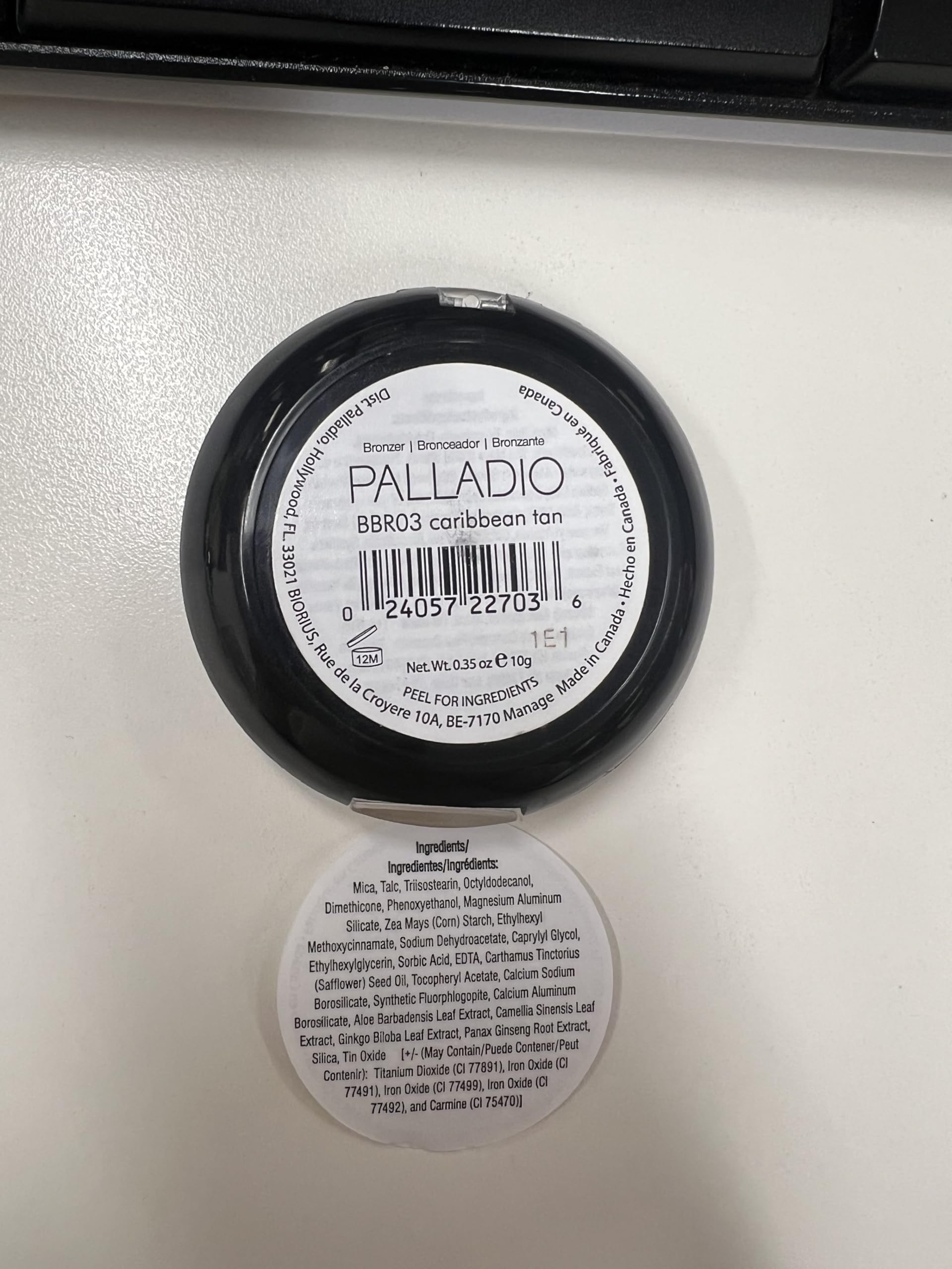 Palladio compact in hand for scale showing travel-friendly size and portability