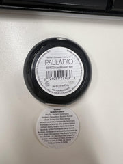 Palladio compact in hand for scale showing travel-friendly size and portability
