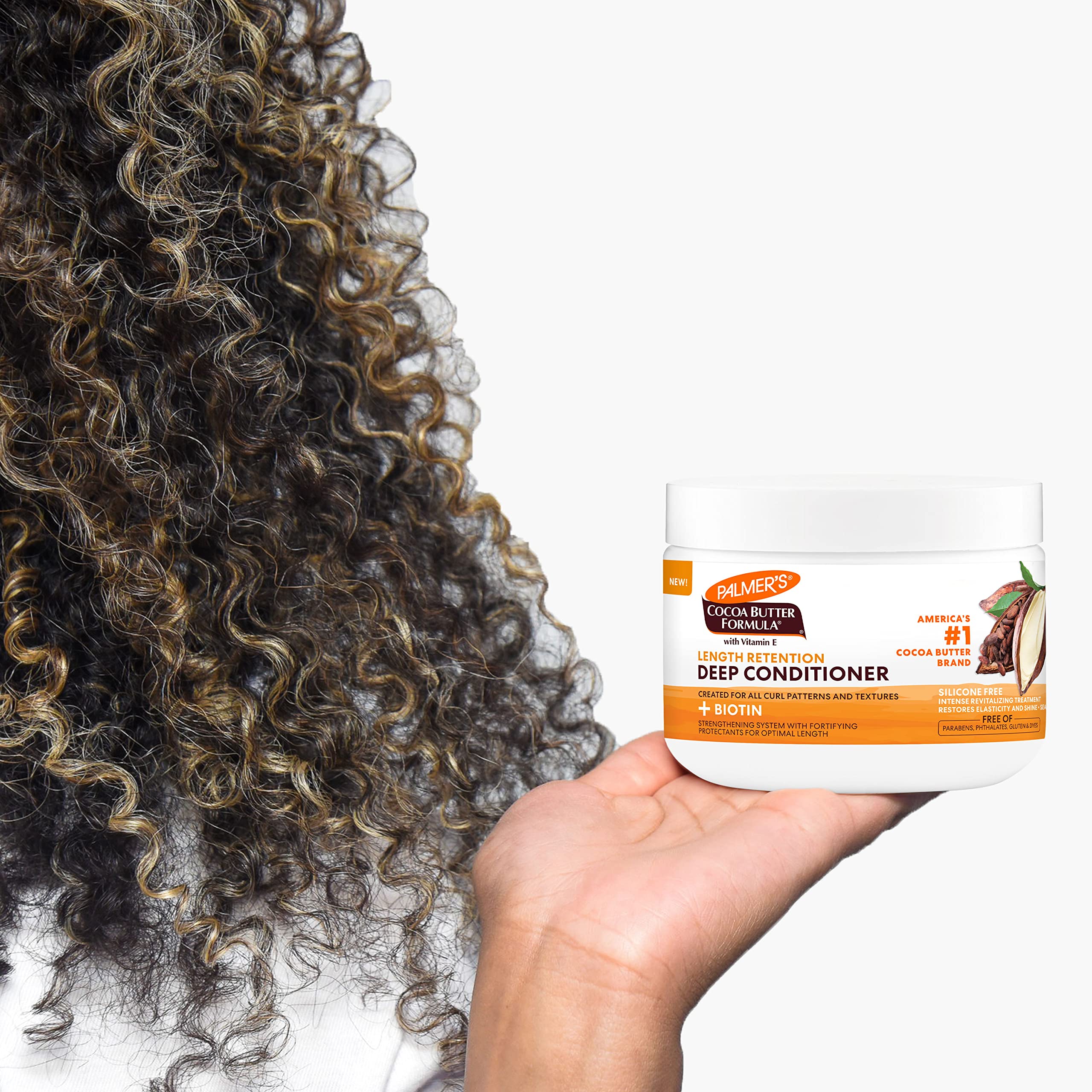 Palmer's being applied to curly hair in shower for deep hydration