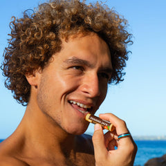 Panama Jack next to sunglasses showing complementary sun-safety routine benefit