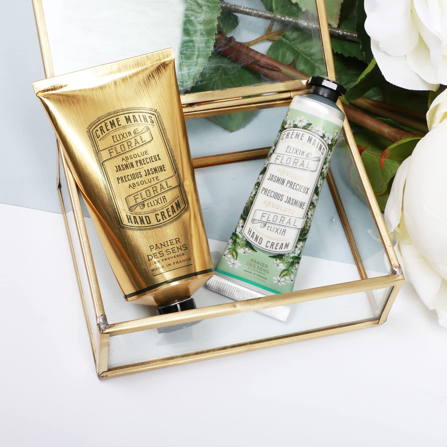 Panier des Sens cream beside a wallet illustrating small 1 fl oz portability