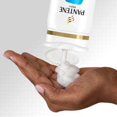 Person washing hair in shower using Pantene for fast 2-in-1 convenience