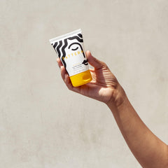 PATTERN conditioner in hand to show 3 fl oz scale for travel convenience