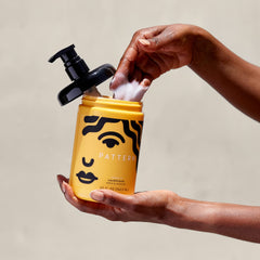 PATTERN applied on wet curls in-hand illustrating hydration and easier comb-through