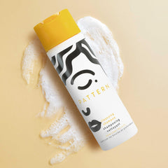 PATTERN mini shampoo inside travel bag illustrating on-the-go freshen-up benefit