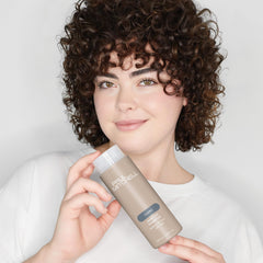 Paul Mitchell Awapuhi travel-size held in hand, ideal for trips and gym bags