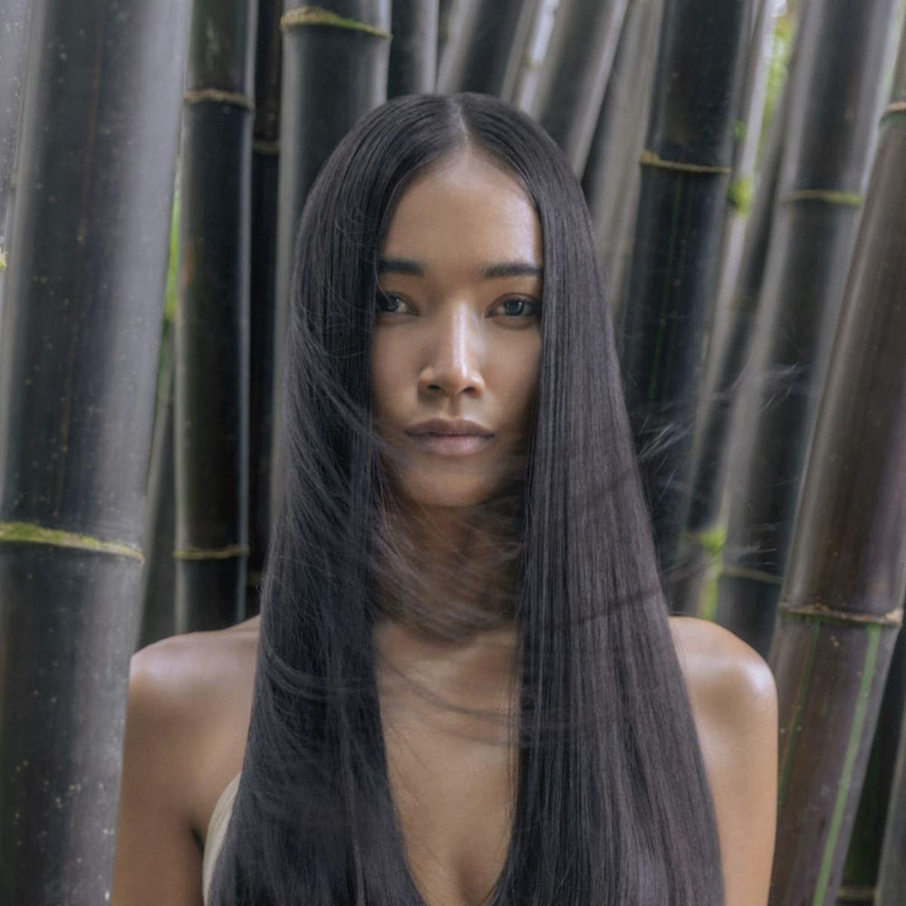 Applying Awapuhi Wild Ginger in shower to wet hair for instant detangling
