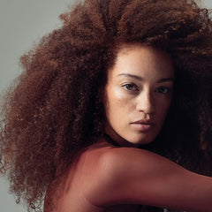 Paul Mitchell conditioner being applied to color-treated hair, improving manageability