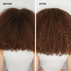 Paul Mitchell 2.5 fl oz bottle in hand to show travel-size convenience and portability