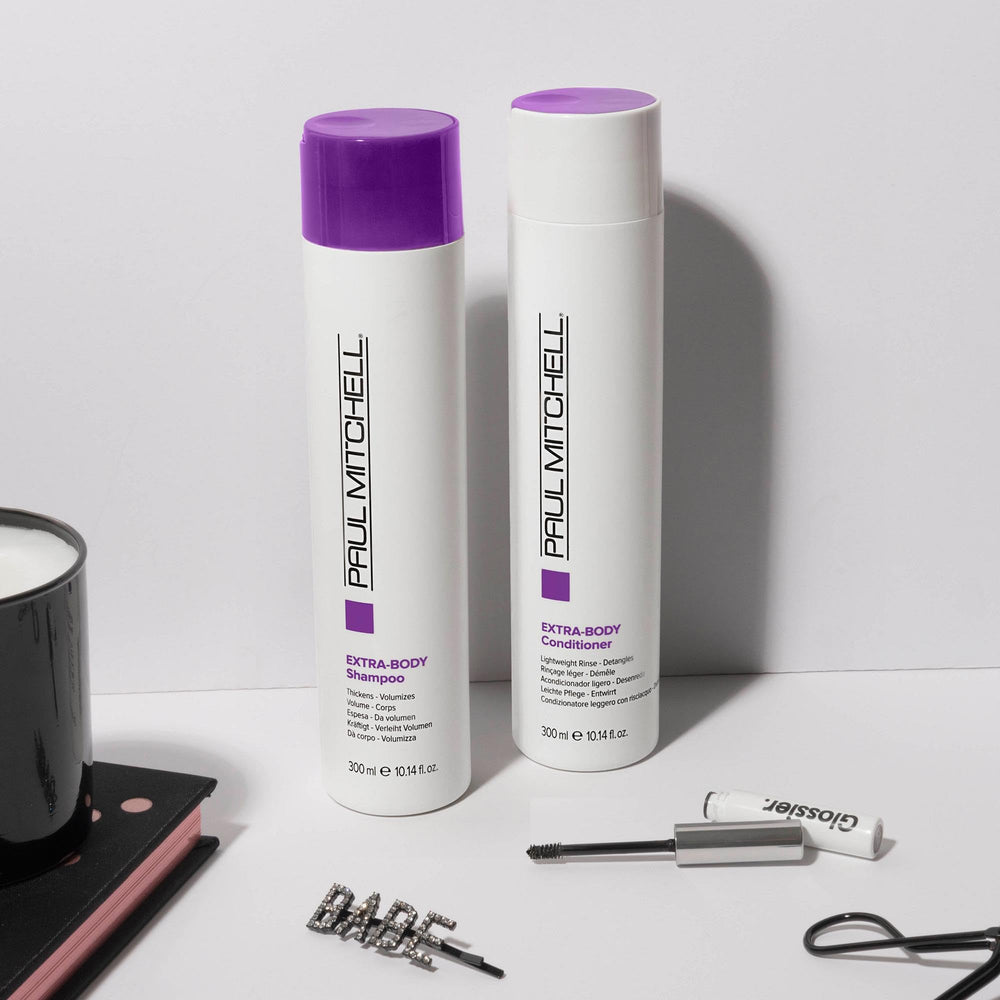Paul Mitchell travel-size beside full bottle showing portable convenience