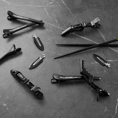 Paul Mitchell clip shown in hand for size scale, easy to carry and store