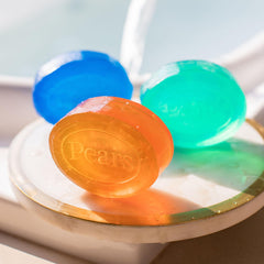 Pears amber soap on bathroom shelf in lifestyle setting evoking warm aromatic bathing