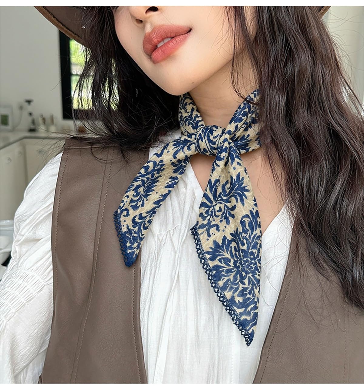 Pemilosci tied as a neck scarf showing polished accessory effect