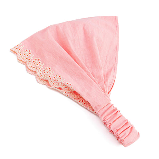 Peppercorn Kids headband front view showing pink eyelet flowers and pretty fit