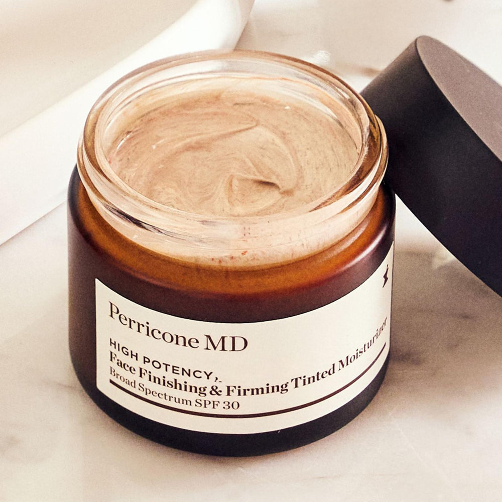 Perricone MD tube beside hand to show 2 fl oz scale and travel-friendly size