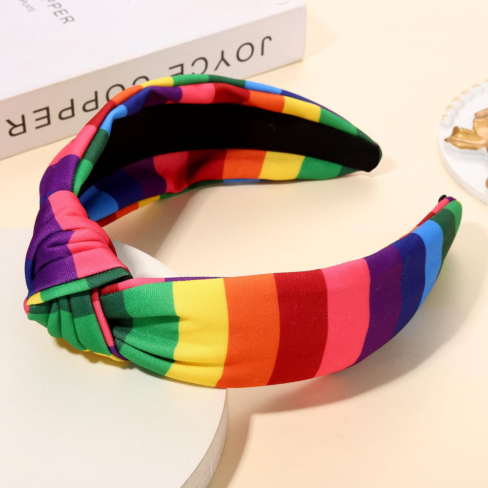 PHALIN headband worn by model outdoors adding festive Pride color and confidence