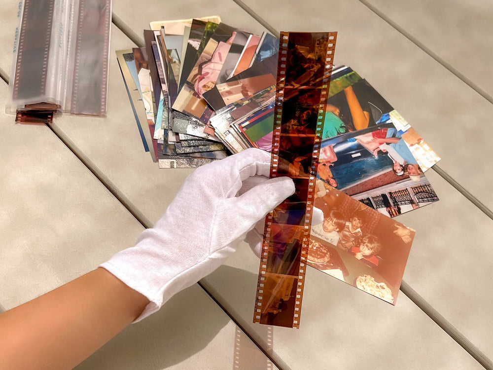 PHOTOMYNE gloves in use handling a vintage photograph to prevent smudges