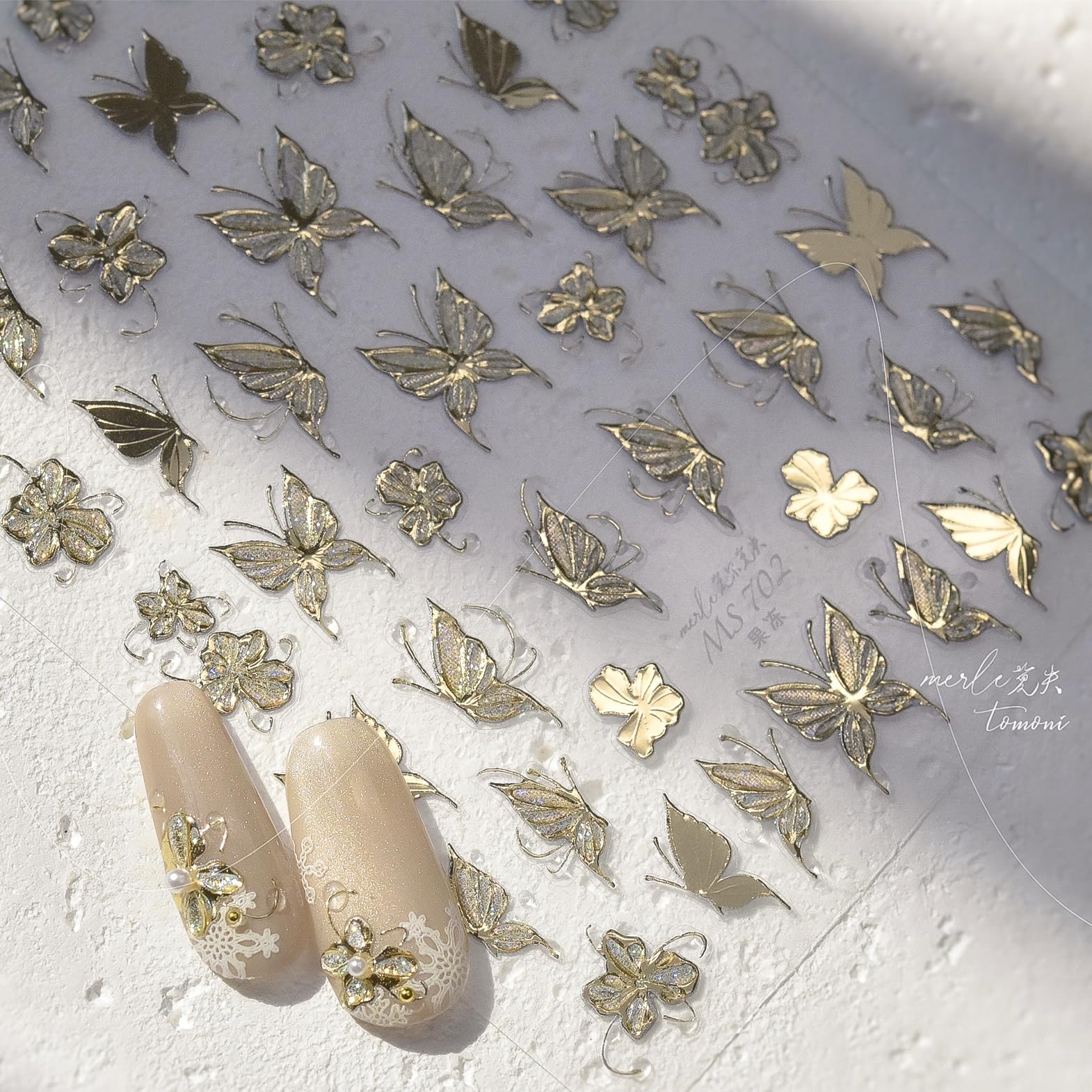 Phuryllic stickers layered on French manicure, enhances classic nails with shine