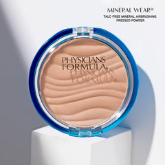 Physicians Formula brush sweeping powder across skin for light setting and shine control benefit longwear