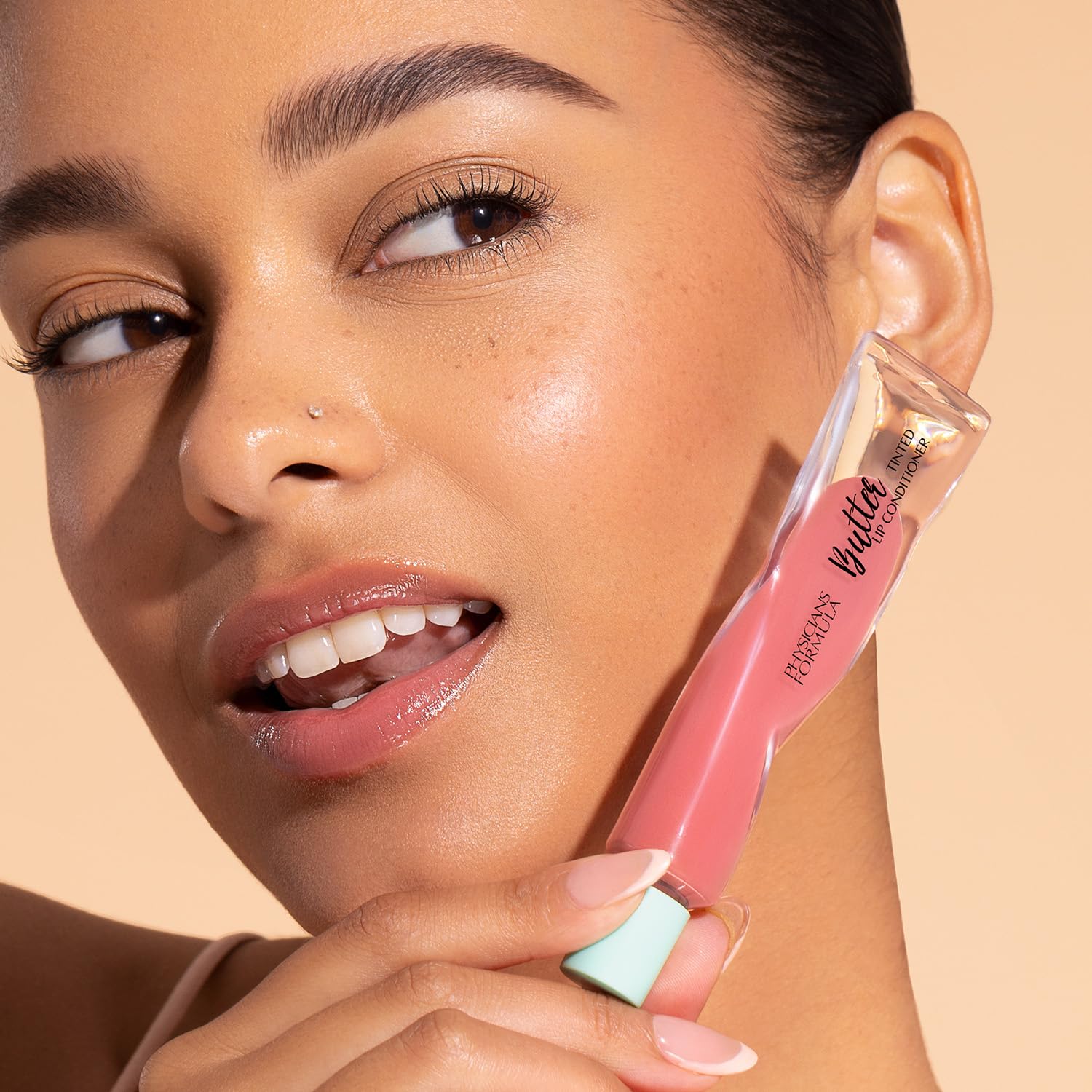 Physicians Formula on model lips illustrating berry tint, glossy look, and hydrated finish