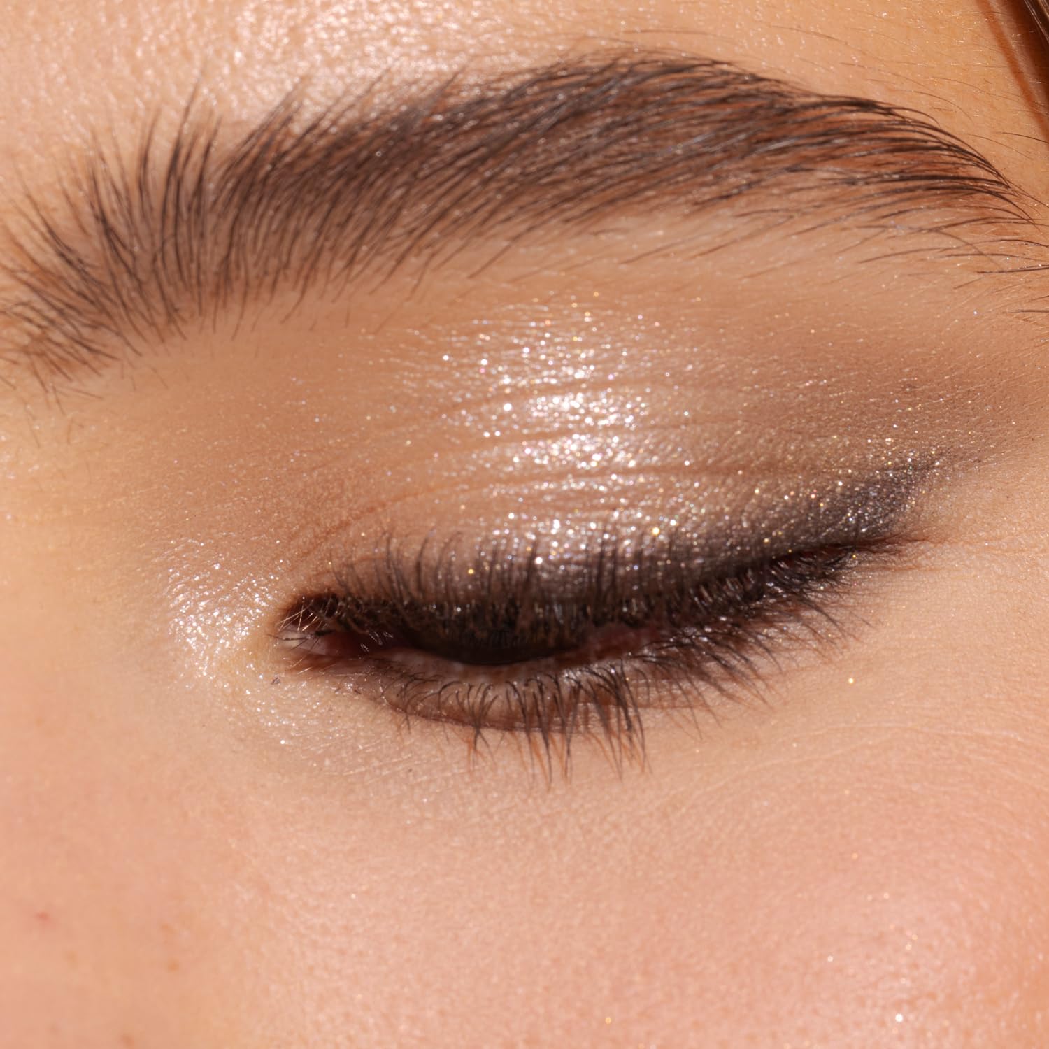 Physicians Formula swatch close-up demonstrating high-pigment nude shimmer for vivid payoff
