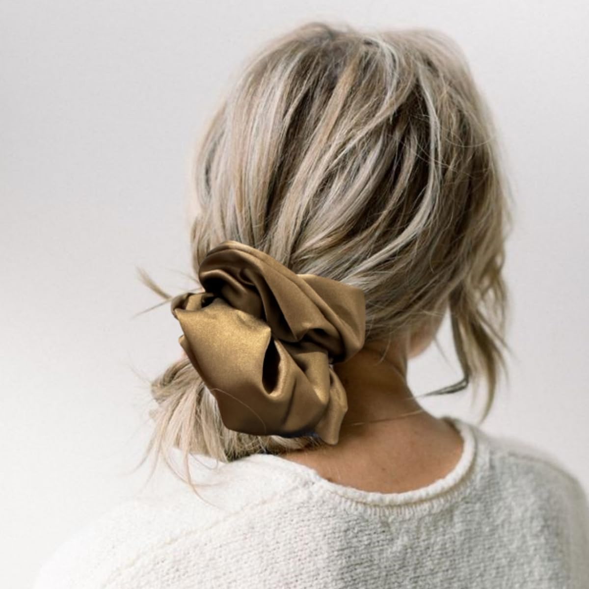 PIDOUDOU scrunchies in lifestyle scene next to outfit suggesting versatile everyday accessory