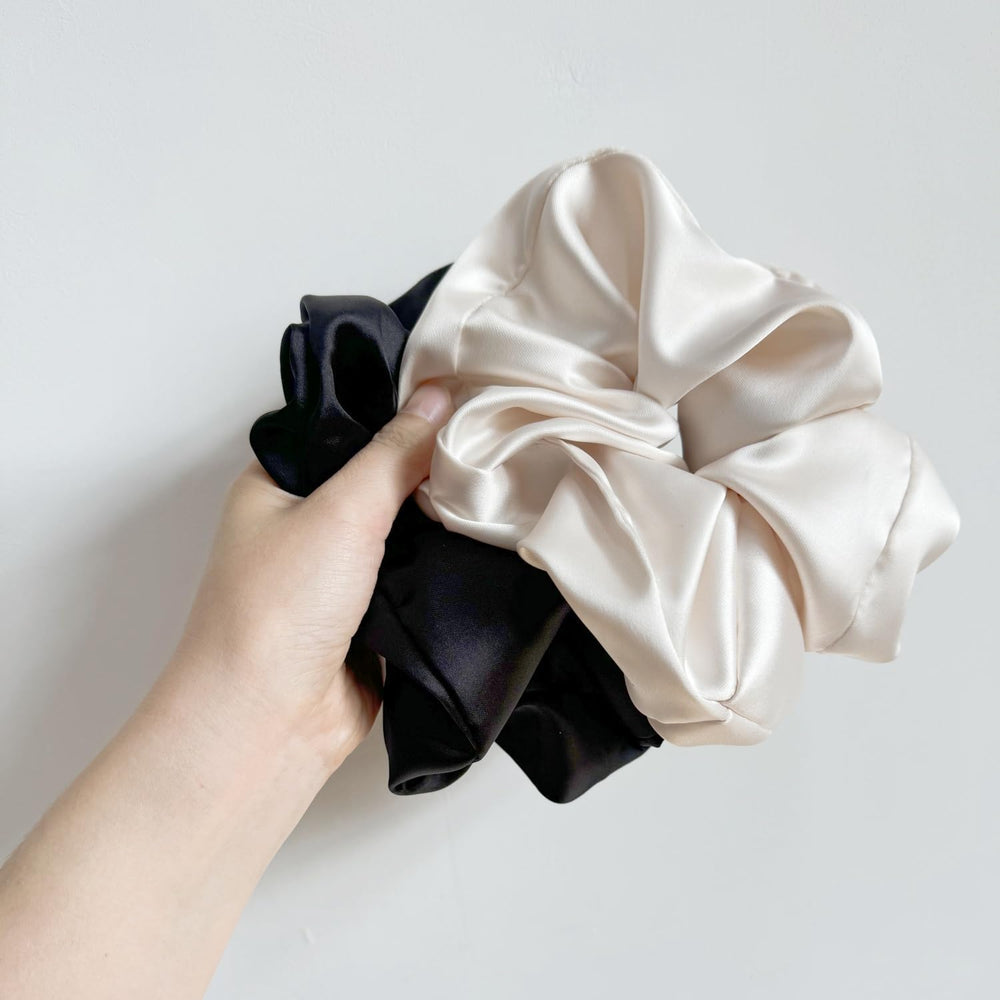 PIDOUDOU scrunchie held in hand to show jumbo scale and secure wrap