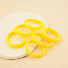 PIDOUDOU hair tie on hand for size reference and easy storage