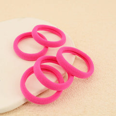 PIDOUDOU hair tie on hand indicating compact size and easy carry