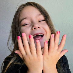 Piggy Paint being applied to a child’s hand showing kid-friendly, low-odor benefit