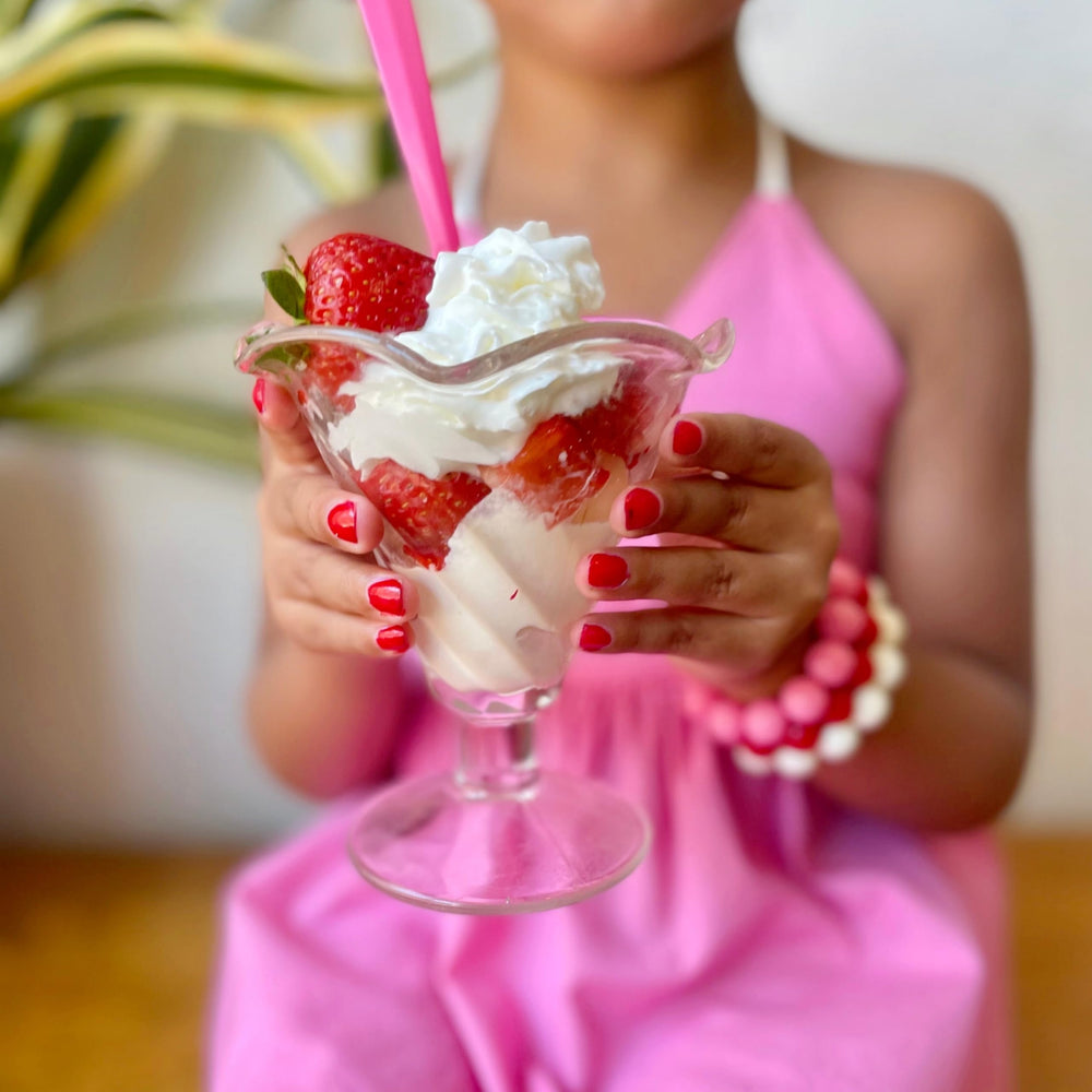 Kids painting nails in a party setting with Piggy Paint showing easy group activity benefit