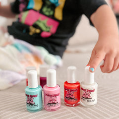 Piggy Paint next to coin showing 0.5 oz size and travel-friendly benefit