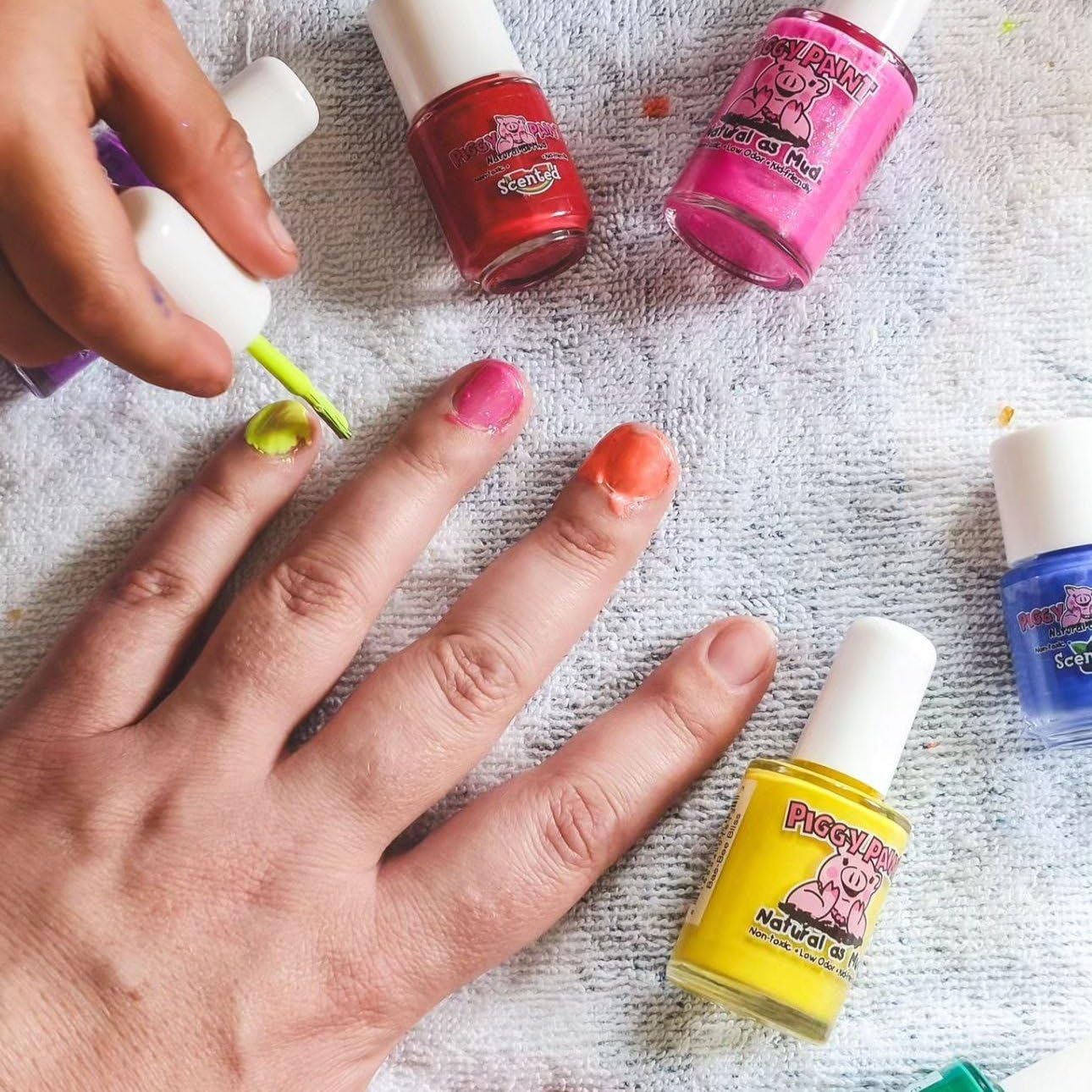Piggy Paint bottle next to a hand for scale showing full 0.5oz size and value benefit