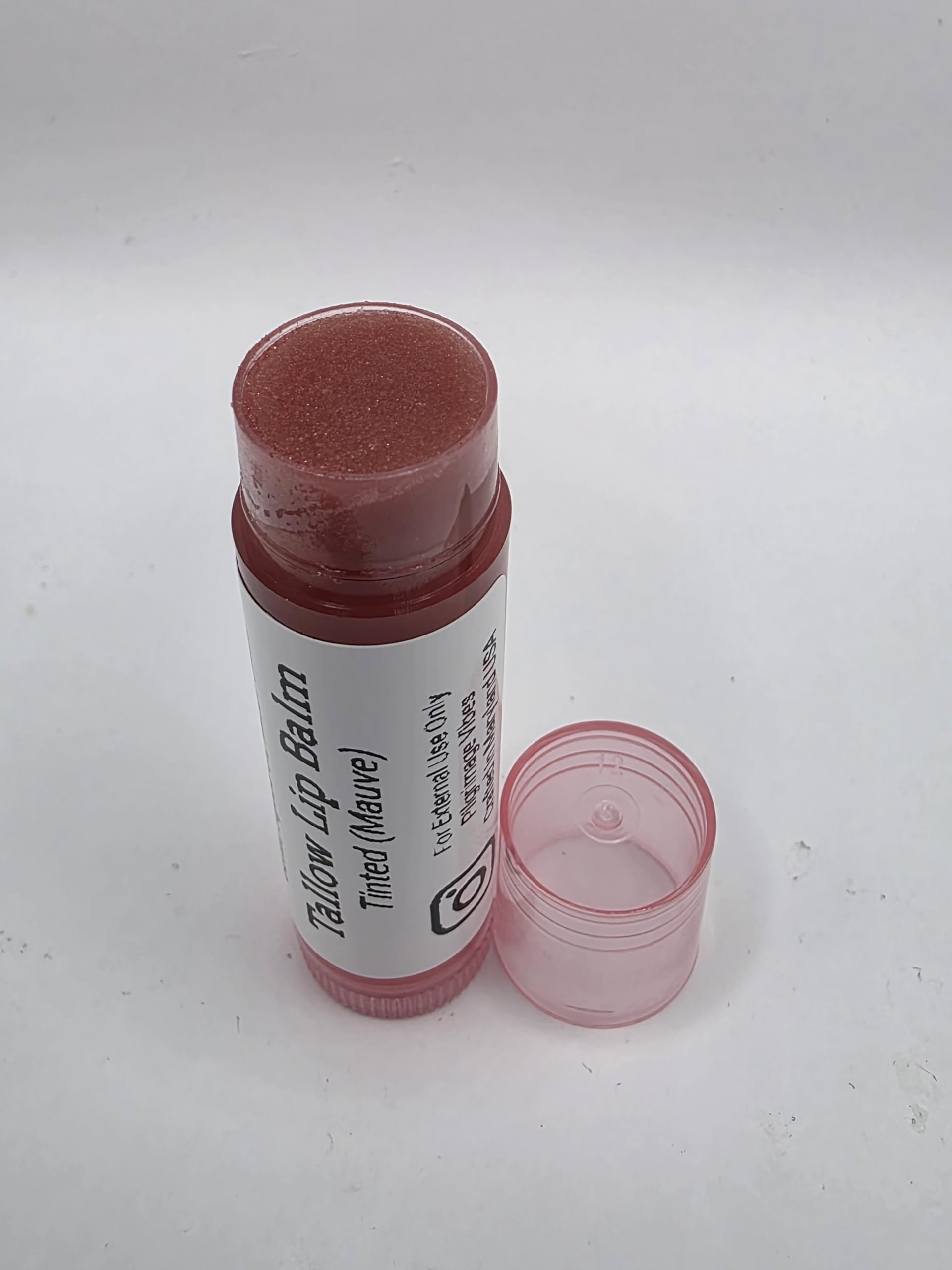 Pilgrimage Vibes application on lips demonstrates subtle mauve tint and moisturized finish