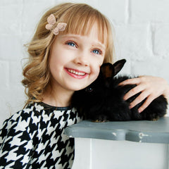 Pinkoriart toddler smiling wearing a butterfly barrette for charming look