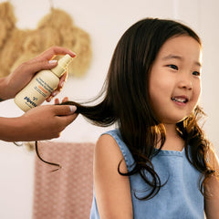 Parent using Pipette detangler on child showing reduced pulling and calmer combing