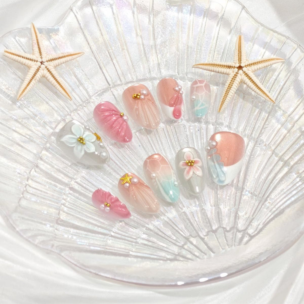 PODUOJIEYI nails worn on hand over beach towel, perfect for vacations and photo-ready looks