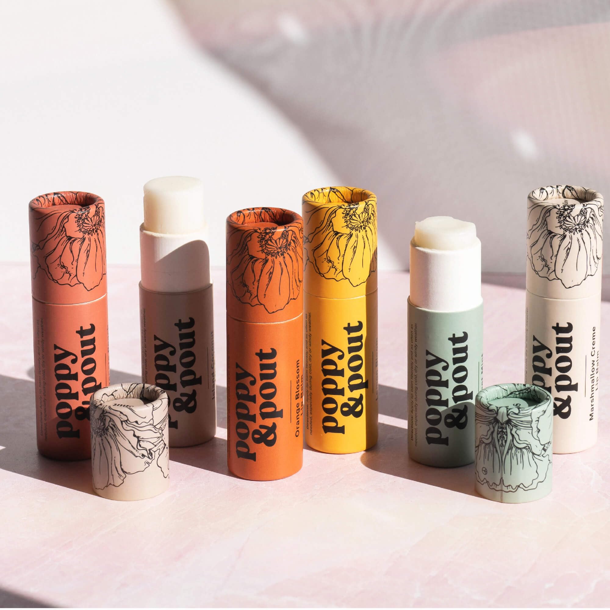 Poppy & Pout flatlay with recyclable packaging emphasizing low-plastic impact