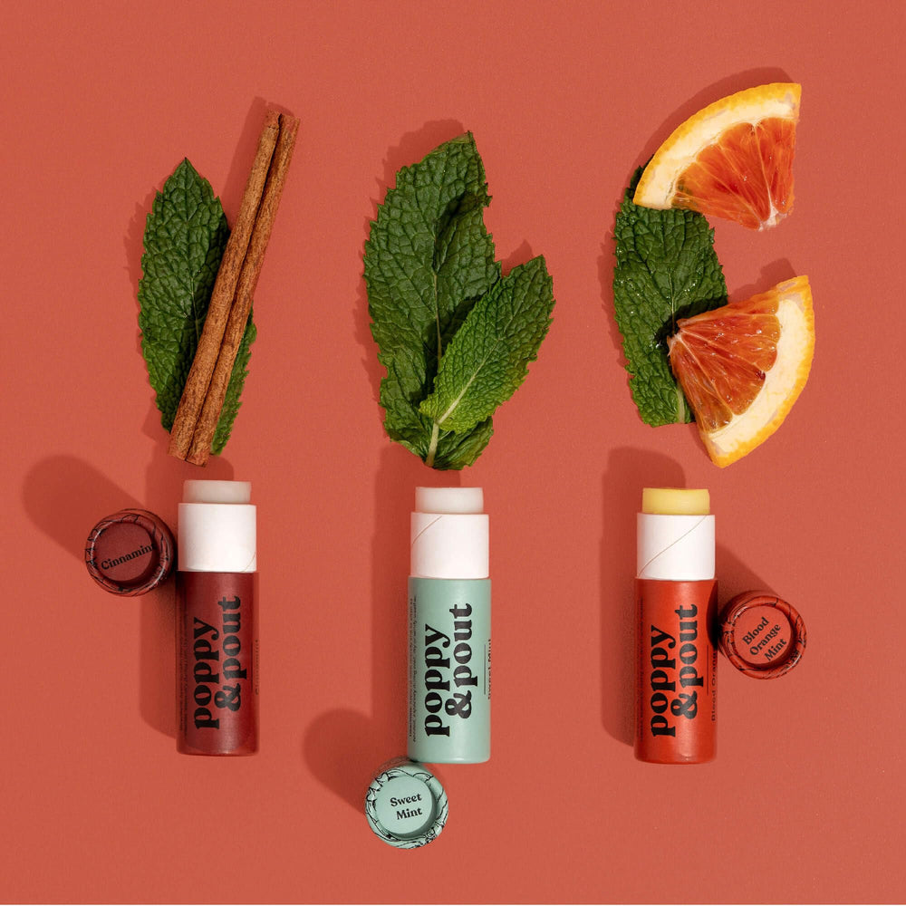 Poppy & Pout ingredients flatlay showing beeswax and coconut oil nourishing benefit