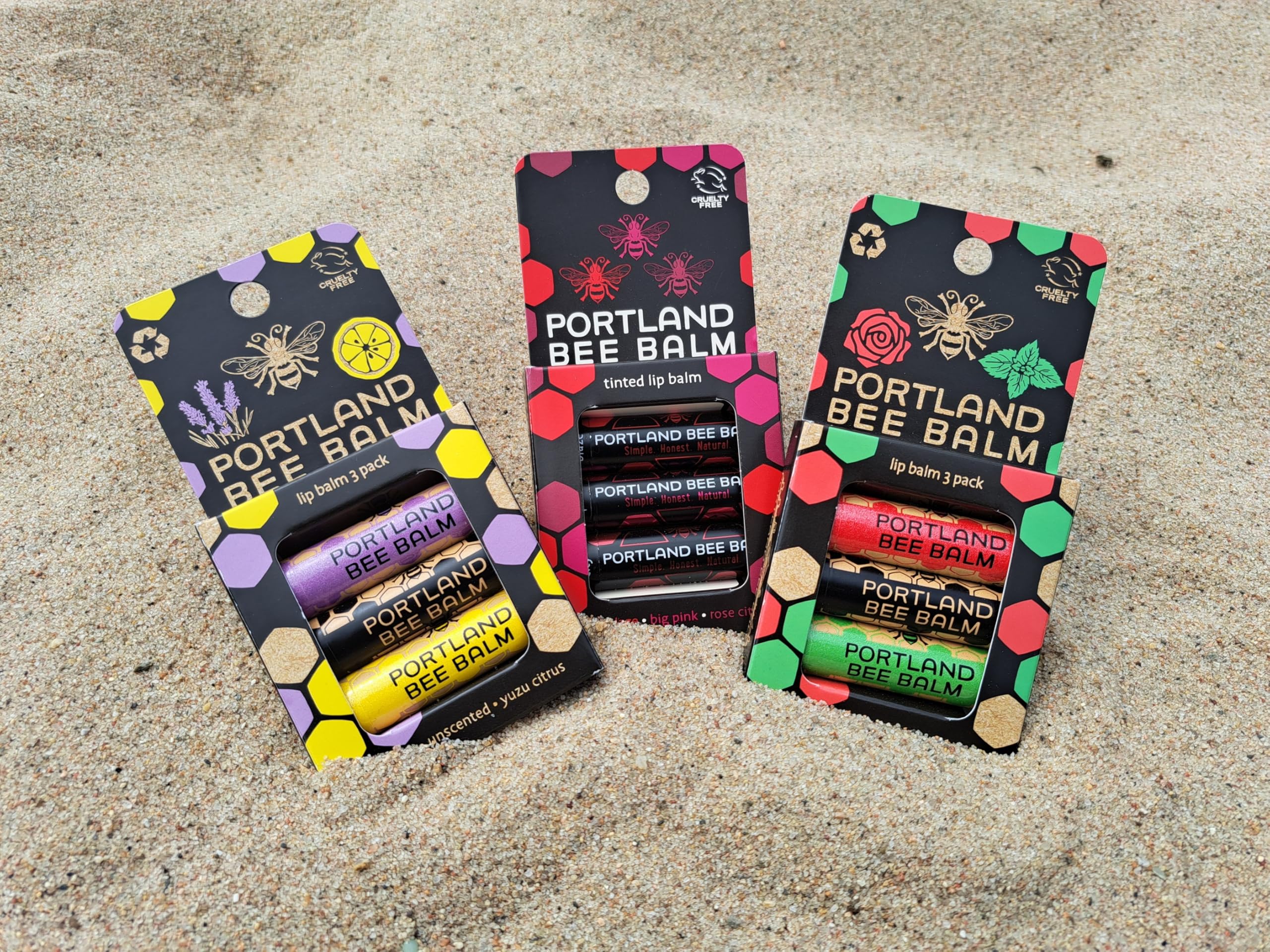 Portland Bee Balm tube next to a quarter showing compact, travel-friendly size