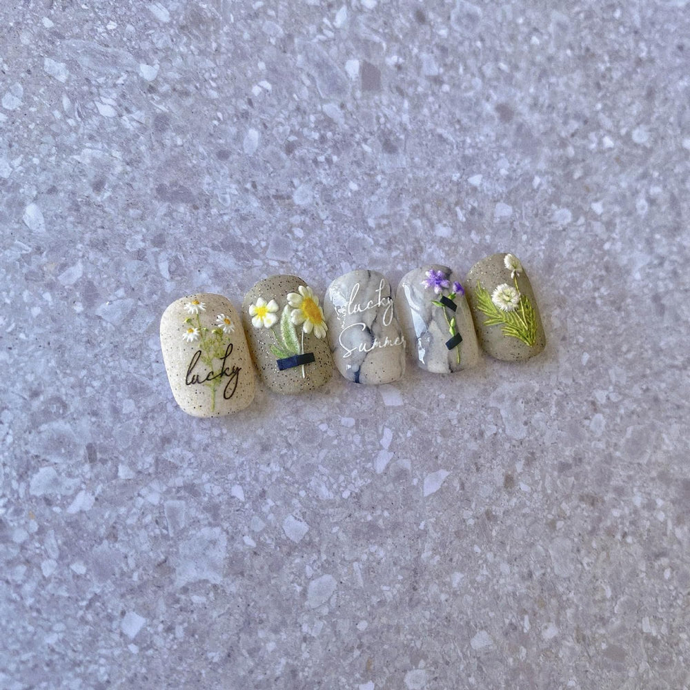 POWPOP summer manicure lifestyle shot showing floral stickers enhancing nails