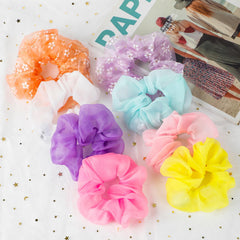 POZILAN scrunchies next to ruler showing size and stretch capacity benefit