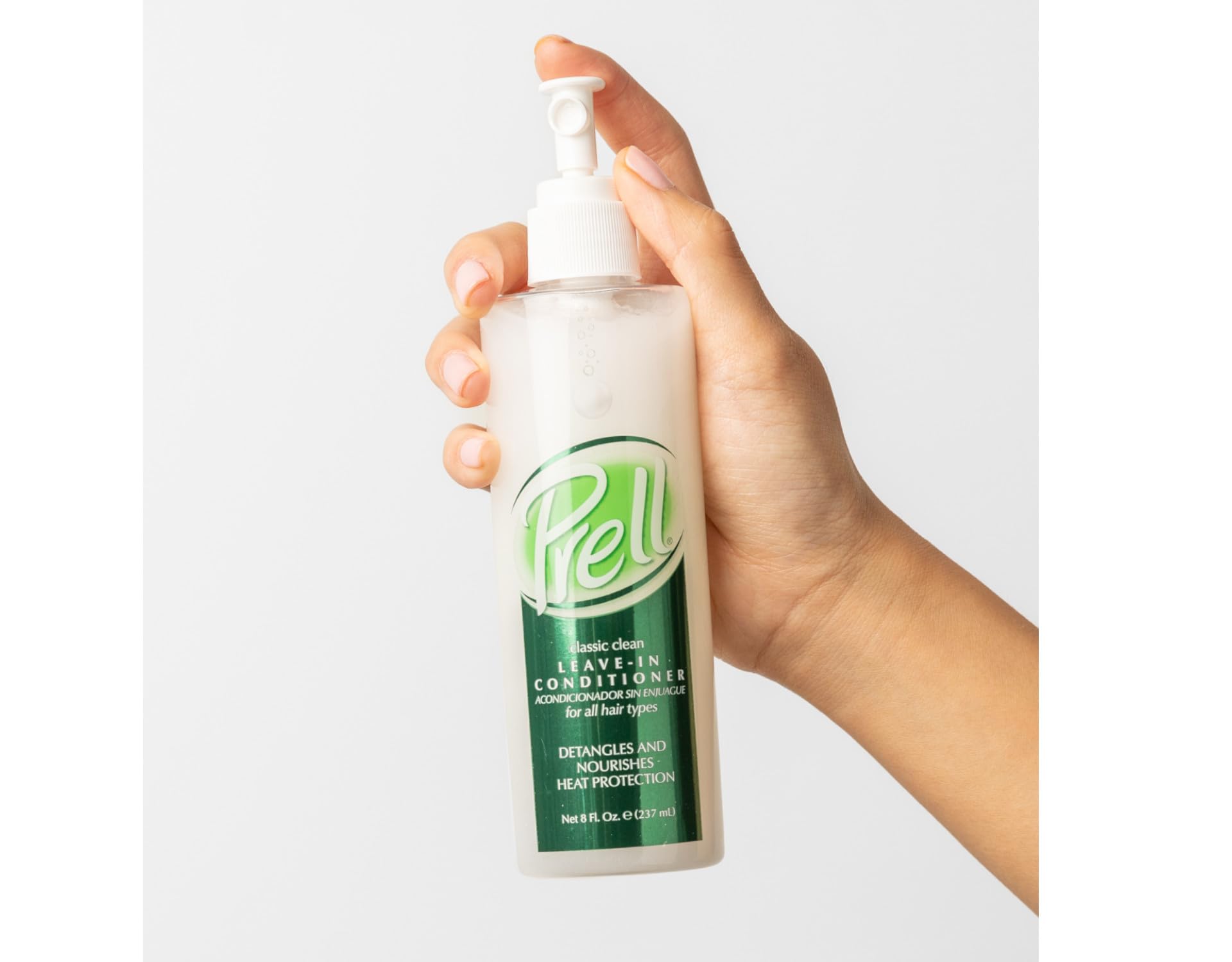 Prell bottle in hand showing 8 fl oz size and travel-friendly convenience