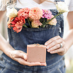 Pretty farm girl soap held in hand for scale to show generous bar size