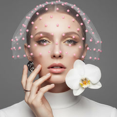 Prudiut pearls applied to model face for festival-ready decoration benefit