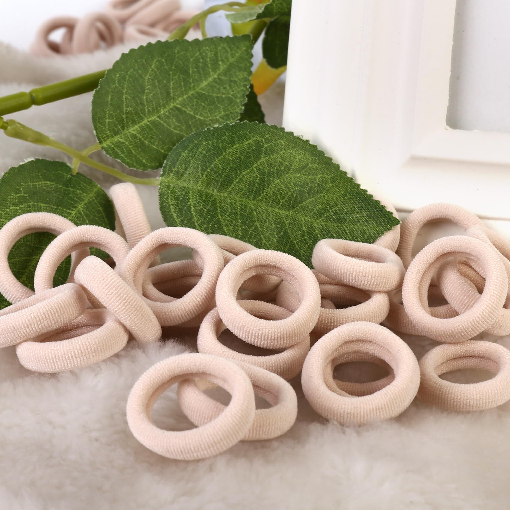 qarwayoc baby wearing pigtails secured with blonde mini hair ties for comfort