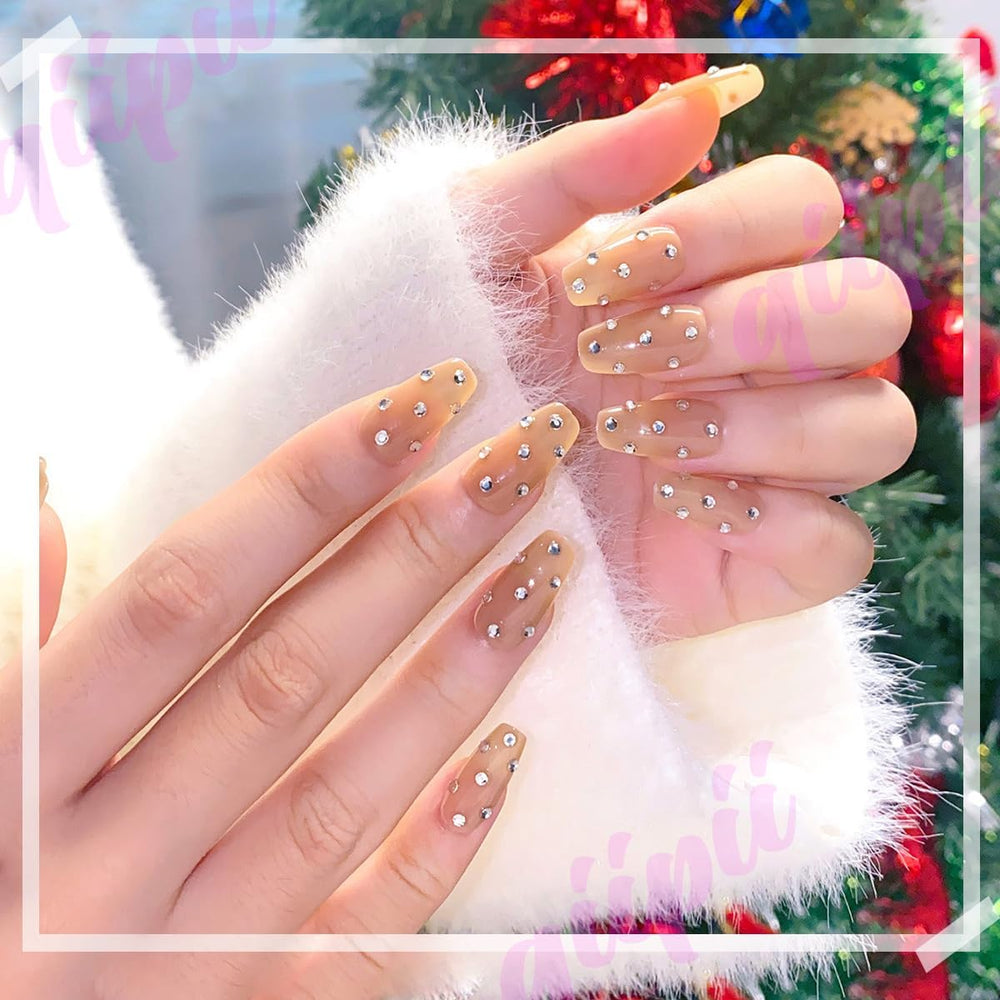 qiipii nails decorated with tiny resin gems showing professional-looking accents