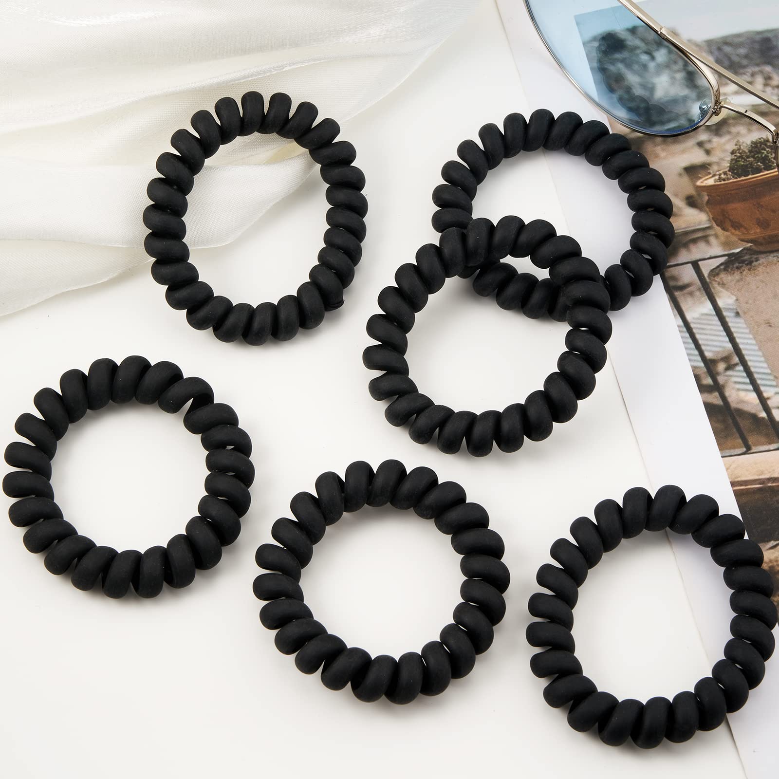 QIUTIMIY coil held in hand to show 2.16-inch diameter and scale for choosing the right size for voluminous hair